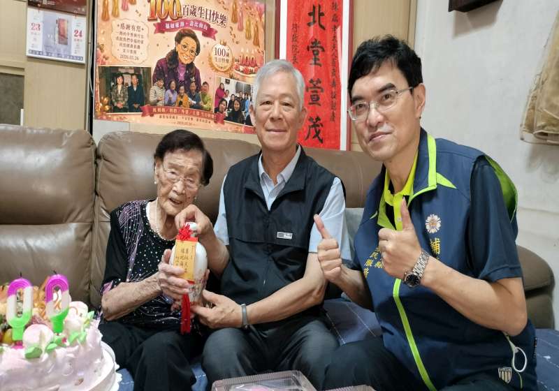圖六金門縣政府許金象主任(中)代表縣長致贈壽酒
