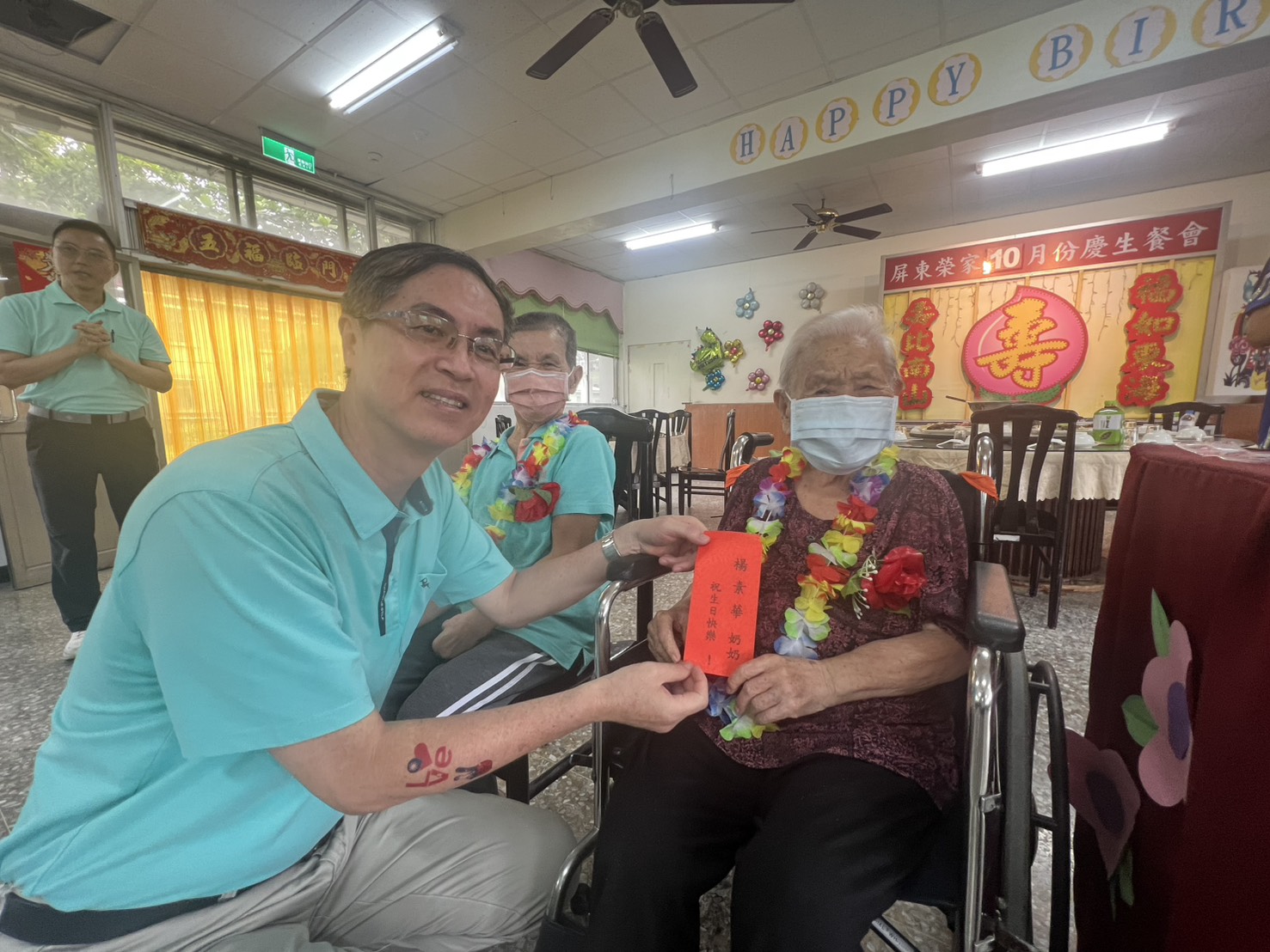 圖2家主任李秦強(左)致贈生日禮金給楊奶奶